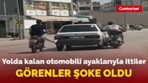 Bursa'da motosiklet sürücüleri yolda kalan otomobili ayaklarıyla ittiler