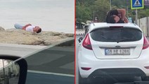 Üsküdar'da ilginç görüntüler: Biri otomobil üstünde, diğeri sahildeki kayalıklarda uyudu