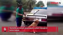 Temizlik personeli süpürgeyle sokak köpeğinin sırtını kaşıdı