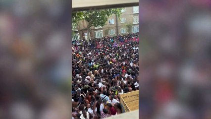 Download Video: Notting Hill Carnival crowds seen screaming and forced to climb over gates as thousands packed into one road with no space