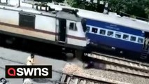 Motorcyclist abandons bike stuck on railway track seconds before high-speed train passes