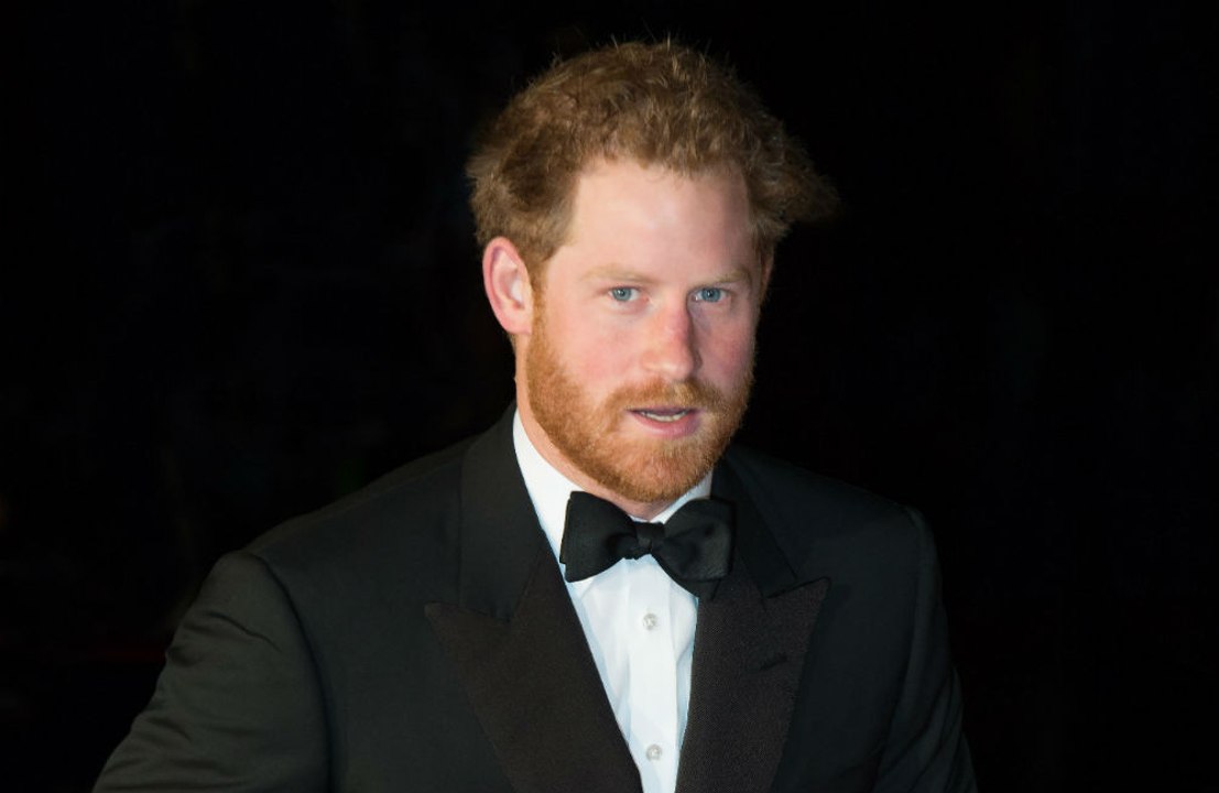 Prince Harry praises amputee former marine for triathlon efforts
