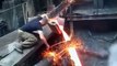 This man is putting his bare hands into hot molten metal