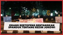 Orang-orang Bertopeng Turun ke Jalan di Malam Hari Bentangkan Spanduk 