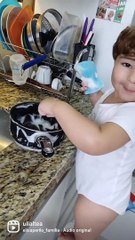 Helpful baby assists mom with the dishes