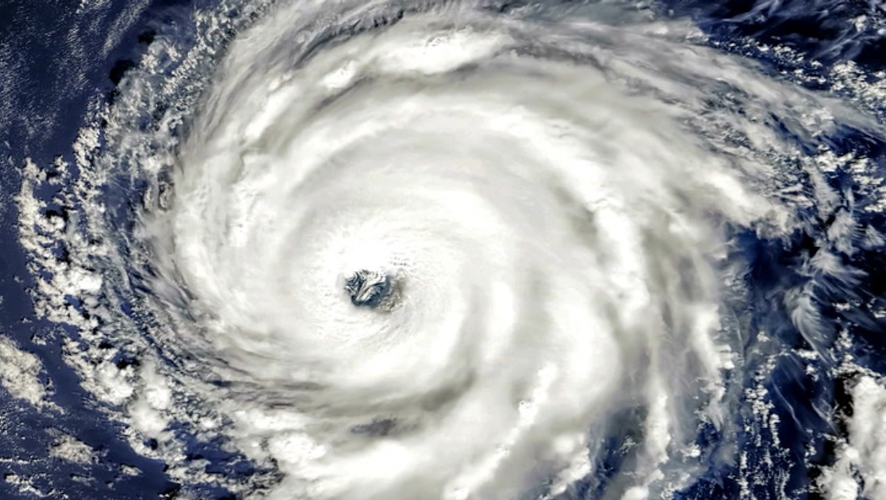 How does wind shear affect a tropical storm sys...