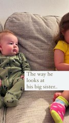 Baby boy preciously smiles at his big sister