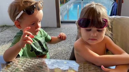 Sweet boy showers little girl with kisses