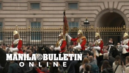 Members of King's Life Guards ride in front of Buckingham Palace following Queen's death