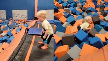 Toddler tries to flip into the foam pit at trampoline park; BOTCHES IT!