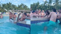 Girl keeps getting pulled into swimming pool by friends