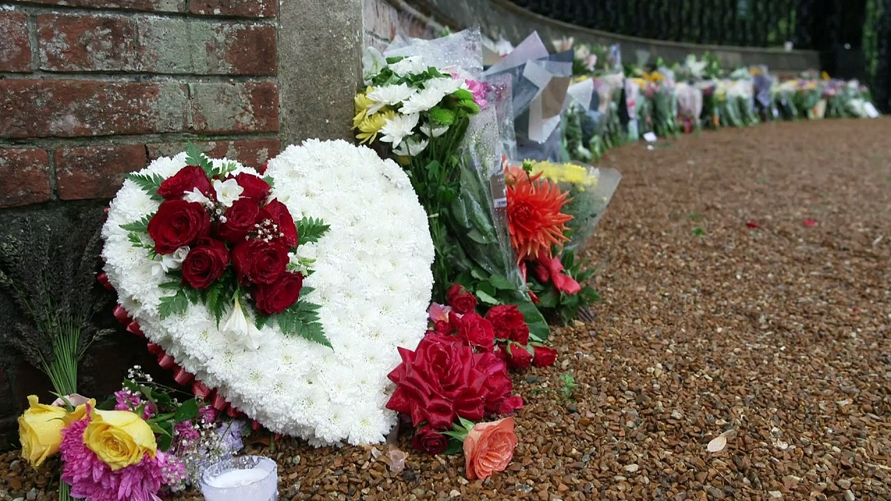 People lay flowers at Sandringham Estate