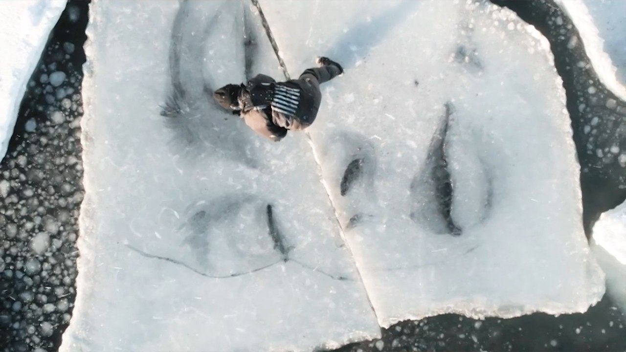 Artist Braves Freezing Water To Paint Ice Block Murals In The Baltic Sea