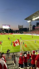 Fan Catches Soccer Ball at Match