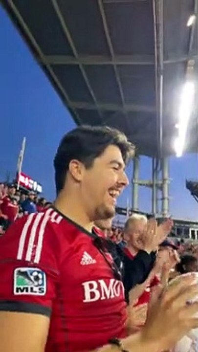 Fan Catches Soccer Ball at Match