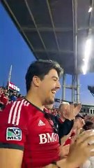 Fan Catches Soccer Ball at Match