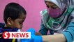 Orphans receive flu shots sponsored by the Council of Federal Datuks of Malaysia