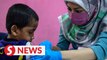 Orphans receive flu shots sponsored by the Council of Federal Datuks of Malaysia