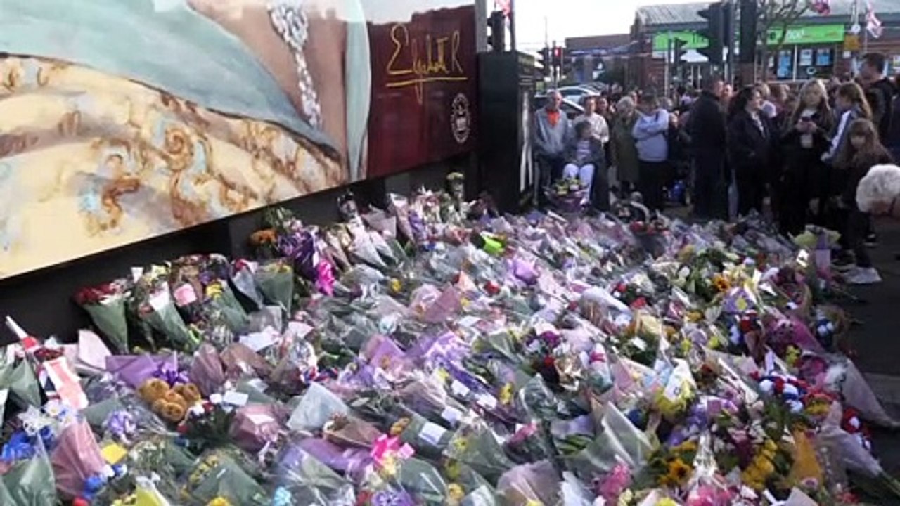People gather a Queen mural in Belfast_Original...