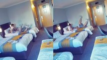 'Son hilariously kicks dad's butt and pushes him off the bed'