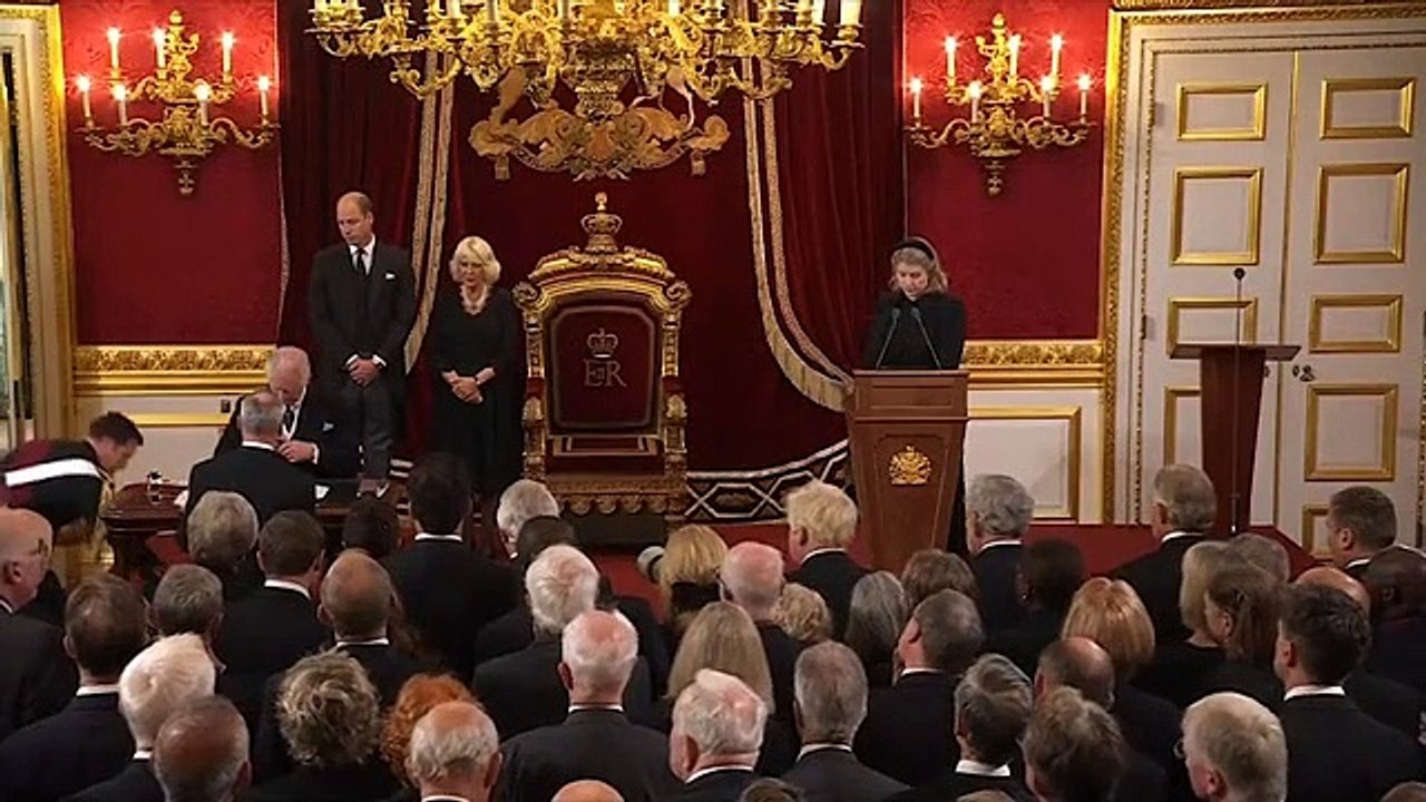 King Charles gestures twice to aides to remove pen tray from desk