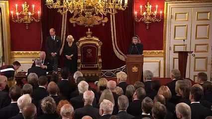 King Charles gestures twice to aides to remove pen tray from desk