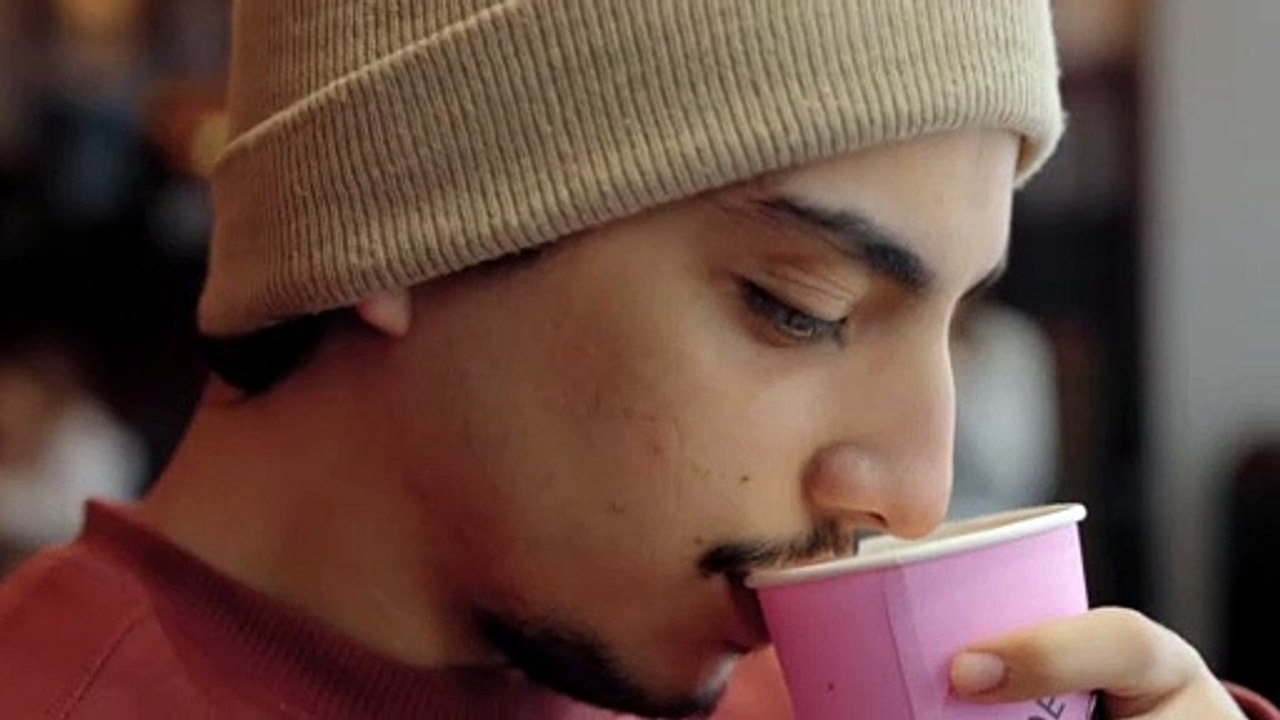 Close-up of a young man drinking coffee