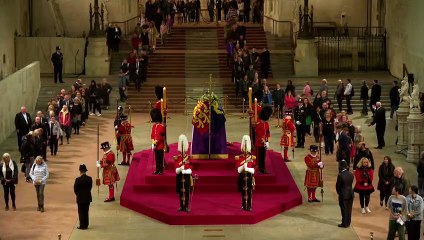 People continue to file past Queen's coffin at night