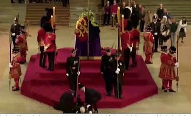 Drama as guard FAINTS off the podium while holding vigil beside Queen's coffin