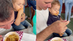 Toddler puts his fast, little hands to work while eating noodles with dad