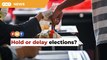 Economists at odds over holding early elections