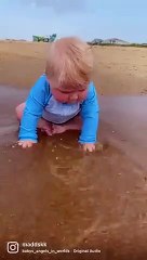 Cute little baby boy enjoys a day at the beach