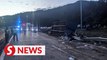 Trailer hauling garbage skids, overturns after Menora Tunnel, driver killed