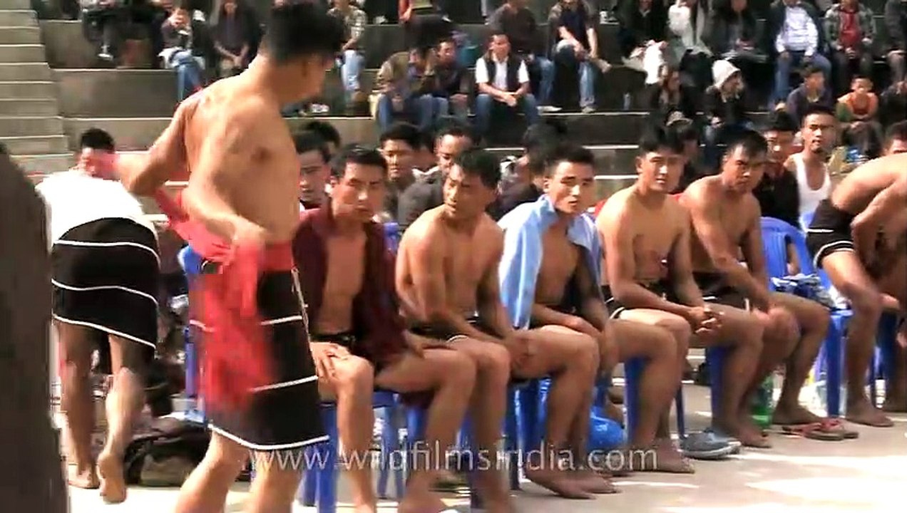 Naga wrester throws an opponent to the ground - Hornbill Naga Wrestling competition