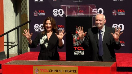 James Bond producers Michael G. Wilson and Barbara Broccoli place their handprints in cement
