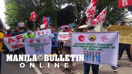 Members of the healthcare sector hold a rally in front of the DOH office in Manila