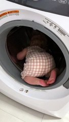 Curious baby decides to explore the washing machine