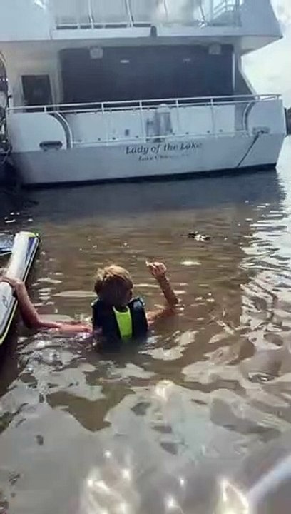 Fearless kid feeds gator face to face