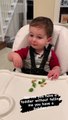 Sneaky toddler tries to hide his broccoli