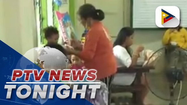 Typhoon-affected families staying in Malabon Elementary School received assistance from DSWD