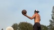Trick Shot Artist Shoots Balls Into Basket While Balancing on Basketballs