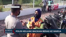 Polisi Keliling Bagikan Beras Ke Warga