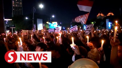 Authorities clean up Indonesia stadium, candlelight vigils for stampede victims