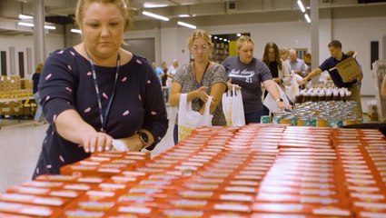 Volunteers pack thousands of bags of groceries in preparation for Hurricane Ian's impacts