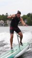Skateboard Hits Guy's Crotch as He Attempts to Perform Skateboarding Trick While Surfing in Water