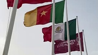 Flags of Fifa World Cup Qatar 2022 qualified nations waving at Doha Corniche