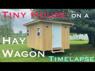 Timelapse of Men Building Small House Over Trailer of Hay Wagon