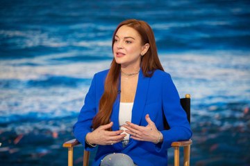 Lindsay Lohan Is Getting Festive in a Poinsettia Inspired Jumpsuit for Her Upcoming Christ
