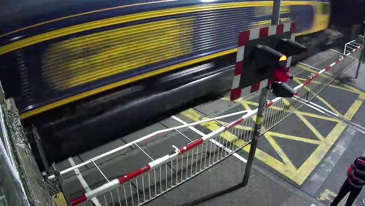 Young man dices with death  as he crosses railway tracks moments before train thunders past