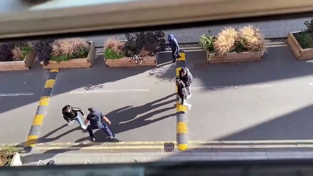 Watch: Armed police stop street fight as group attack each other 'with weapons'